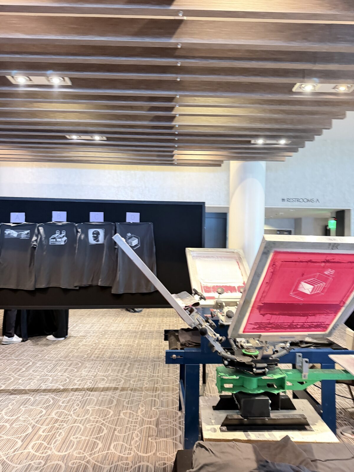 Merch Troop live printing — fresh prints off the platen